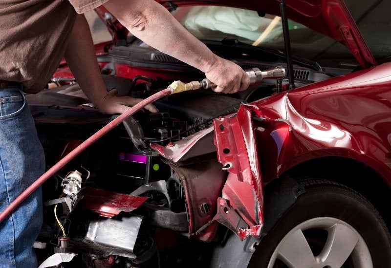 man fixing car