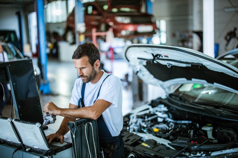 Mechanic Working on Car Diagnostics in a Repair Shop in Surrey, BC