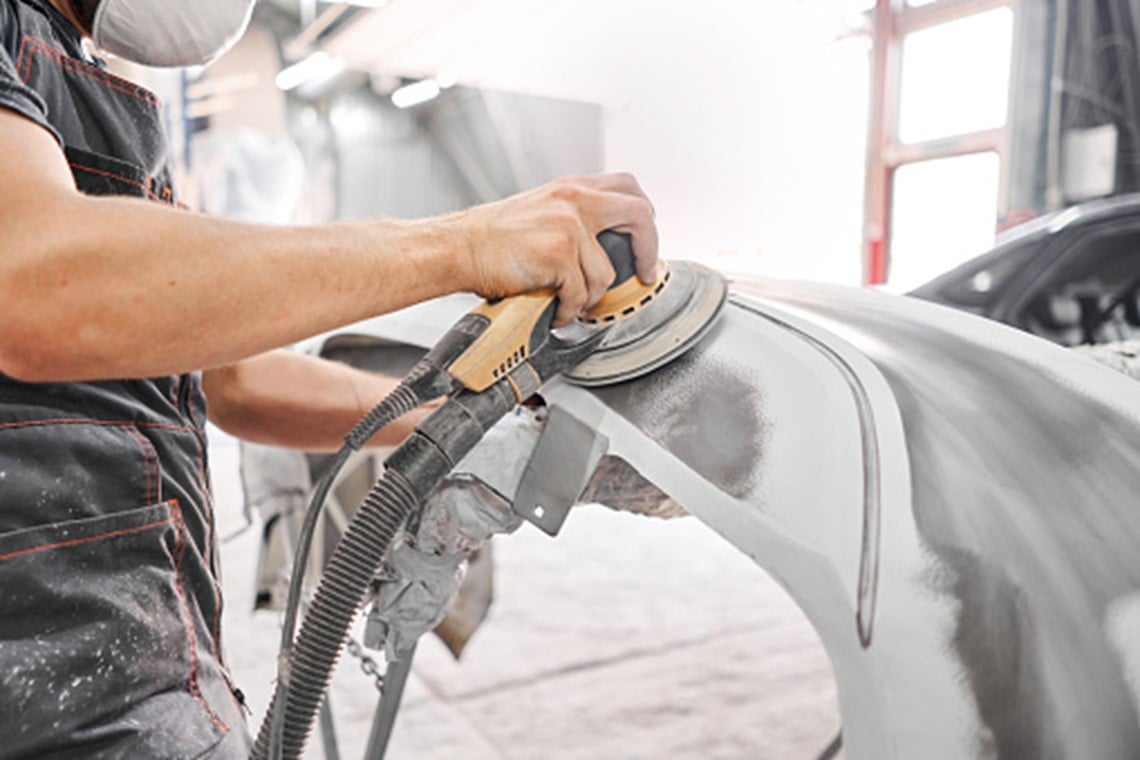A man is working in a car workshop in Surrey, BC