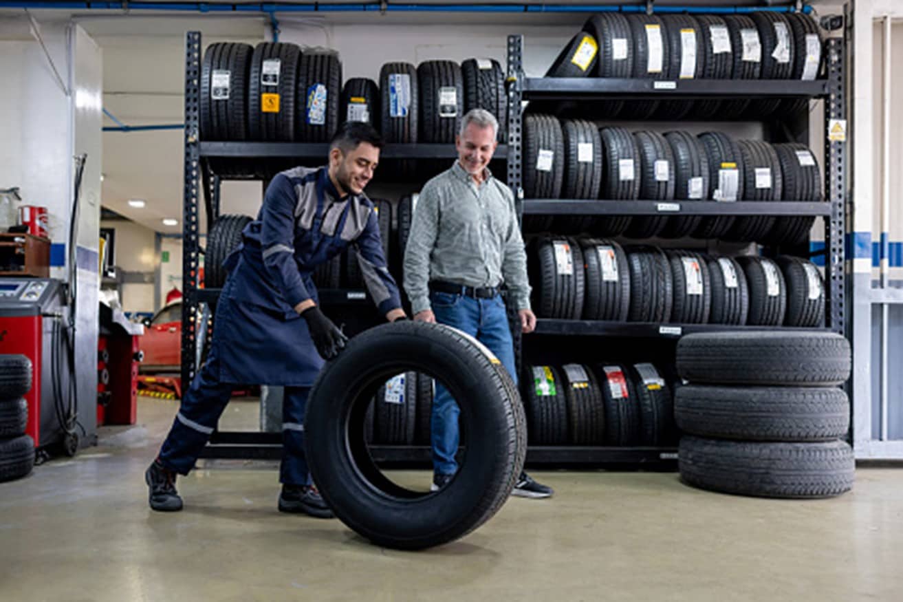 A man is carrying a tire in Surrey, BC