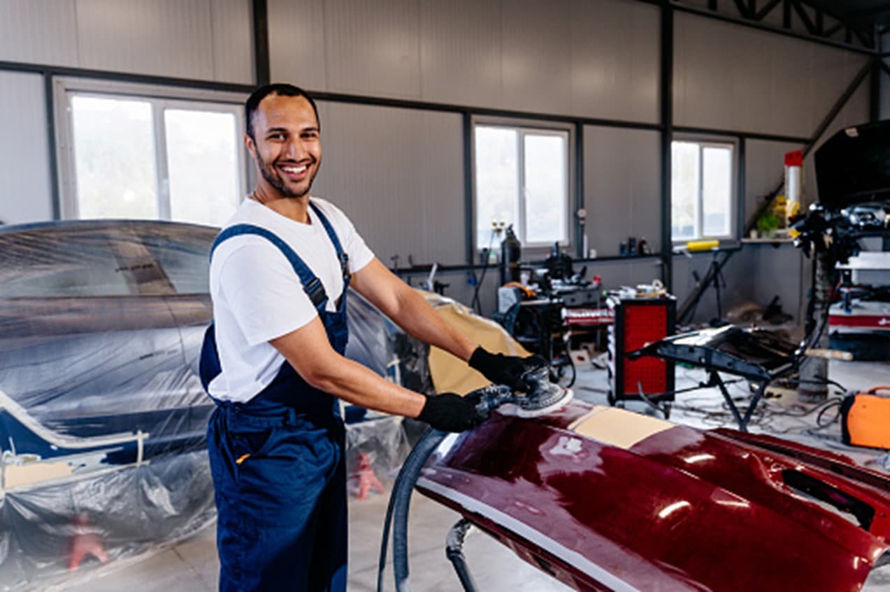 A man is working in a car workshop in Surrey, BC
