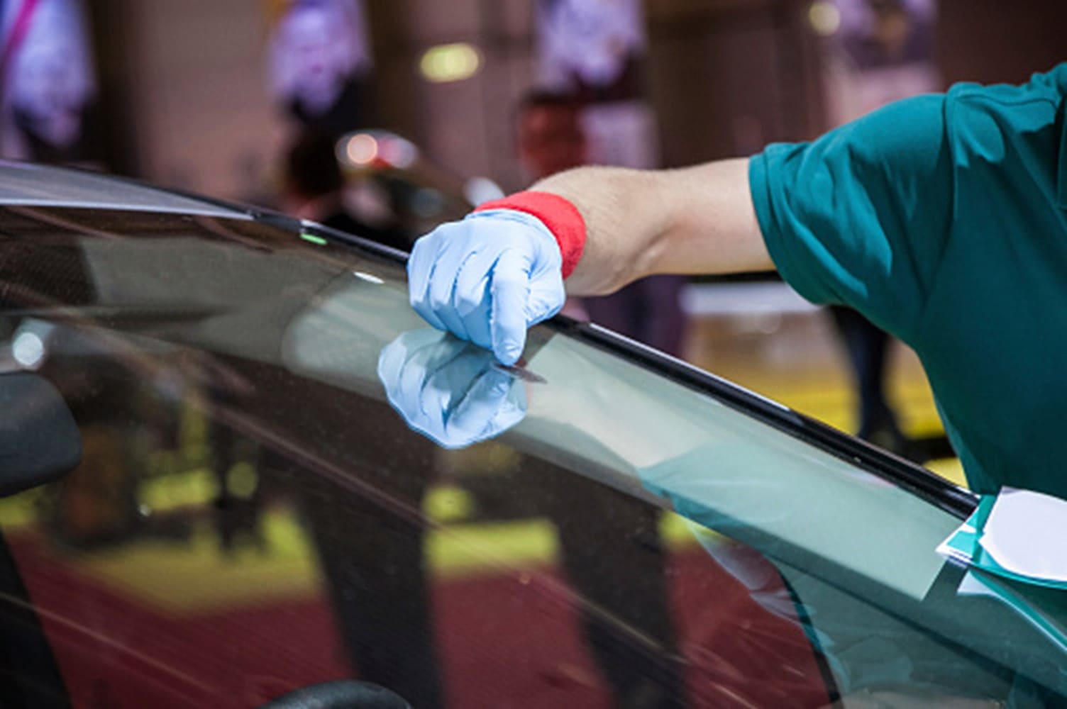 A man is cleaning a windshield in Surrey, BC